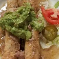 Chicken Flautas · Two crispy flour tortillas stuffed with shredded chicken. Topped cheese sauce. Served with r...