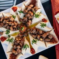 Hummus With Lamb · Lamb sautéed with spices & olive oil served in center of hummus plate.