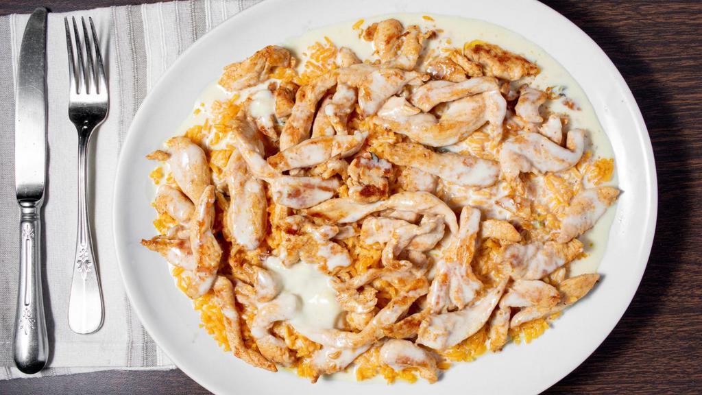 Mi Lindo · Grilled chicken topped with cheese sauce served over a bed of rice.