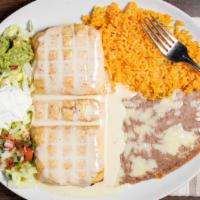 Chimichanga · Deep fried tortilla stuffed with beef or chicken topped with cheese sauce, served with rice,...