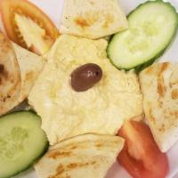 Hummus Dip · House made Hummus served with cucumbers, tomatoes & grilled  pita bread.