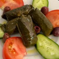 Dolmas Plate (Stuff Grape Leaves) · Stuffed Grape Leaves with Olives, cucumbers & tomatoes drizzled with Olive oil