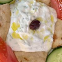 Tzatziki Dip · House made Tzatziki served with cucumbers, tomatoes & grilled pita bread.