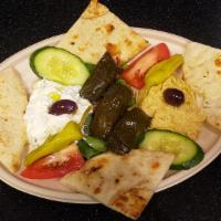 Meze Platter · (Sample Appetizers) House made Tzatziki & Hummus dip with stuffed Grape leaves and grilled p...