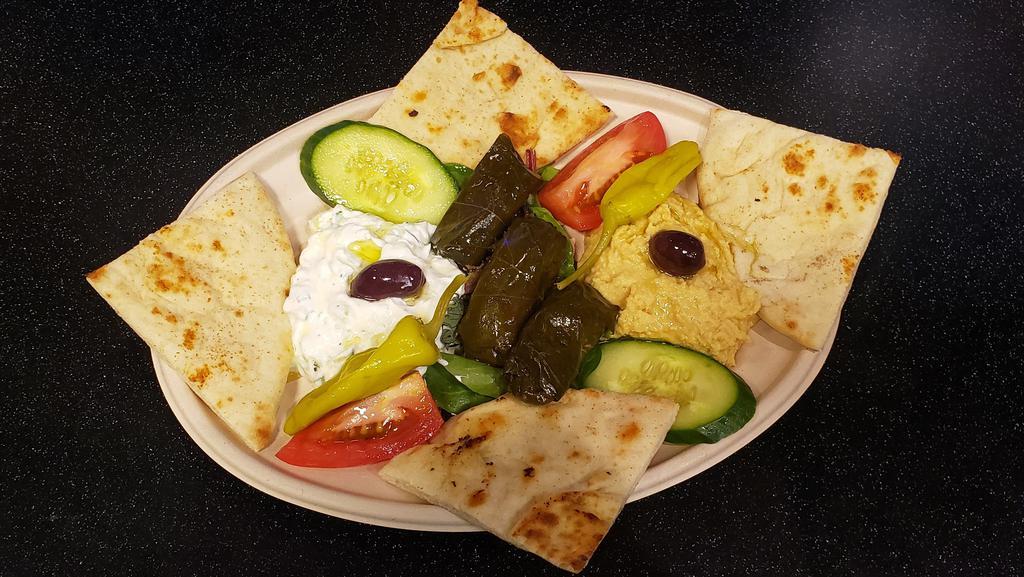 Meze Platter · (Sample Appetizers) House made Tzatziki & Hummus dip with stuffed Grape leaves and grilled pita bread