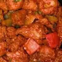 Chili Chicken  · Fried chicken pieces tossed in a spicy chili sauce with onions and bell peppers.