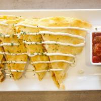 Quesadilla  · Grilled chicken, colby jack cheese and bacon in a flour tortilla, served with salsa and sour...