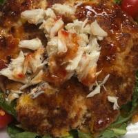Signature Crab Cake · Small 3 oz Crab Cake with our Remoulade Sauce.

* Picture shows Added Crab meat for an extra...