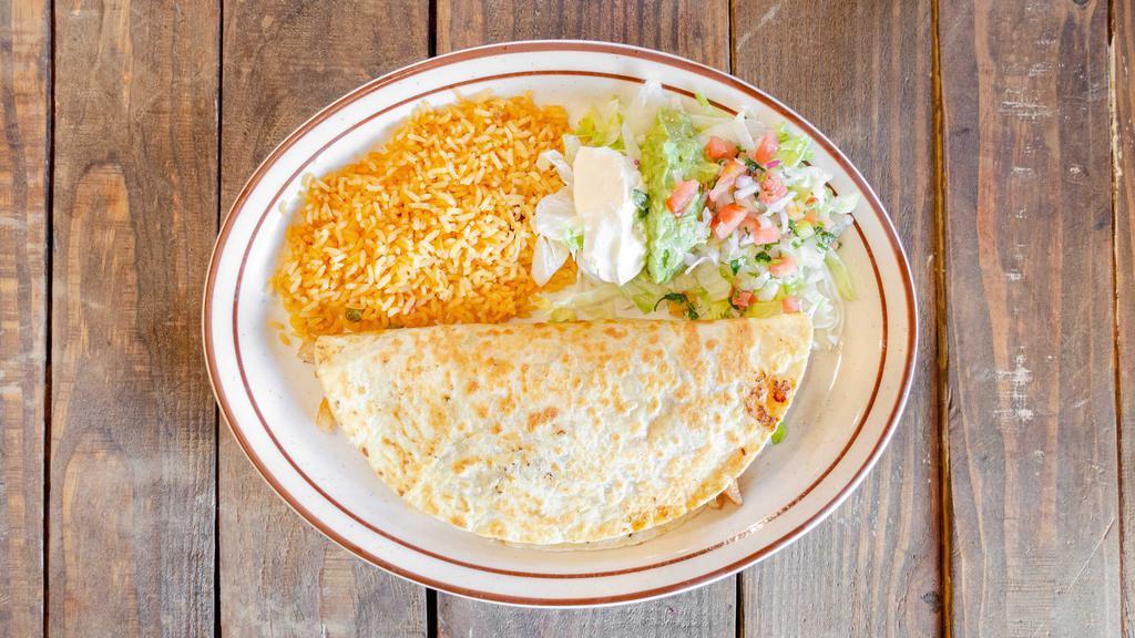 Quesadilla Fajita · Grilled chicken, steak or mix, filled with onions, bell peppers and tomatoes.  served  with  rice,  lettuce,  sour  cream,  guacamole  and  pico de gallo.