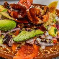 Molcajete Jalisco · Steak,  grilled  chicken  and  shrimp,  fresh  cheese,    cactus,    rice,    beans,    lett...
