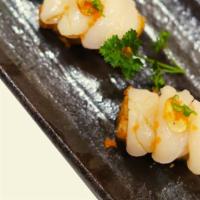 Savage Roll · Crispy rice topped with scallop sashimi, garlic, and olive oil.