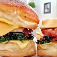 Bacon,  Egg And Cheese · 4 strips of bacon, over well egg and two slices of american cheese between two slices of but...