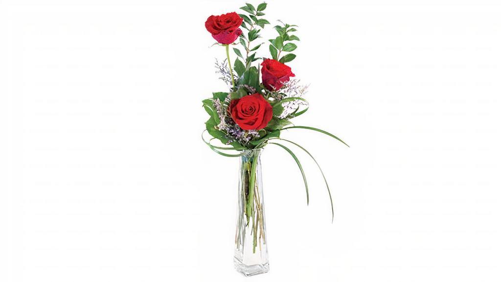 3 Roses W/ Bud Vase · This darling bud vase is a sweet treat for your loved ones and is the perfect way to show you care! It features 3 roses, purple caspia, and lush greens for a simply elegant look that is a surefire way into their heart. Send Three Roses to someone who needs a little love today!