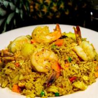 Pineapple Fried Rice · Fried rice with curry powder, pineapple, raisins, carrots, peas and onions.