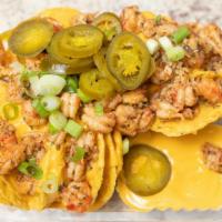 Crawfish Nachos · tortilla chips topped with nacho cheese sauce, savory Louisiana crawfish tails, green onions...