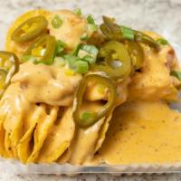 Voodoo Nachos (Shrimp) · nacho chips topped with spicy creole cheese sauce , Gulf Shrimp, green onions & jalepenos