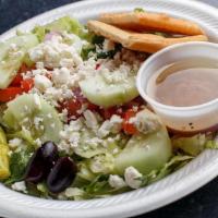 Small Greek Salad · Fresh garden greens, tomatoes, red onions, cucumber, feta cheese, Kalamata olives, and peppe...