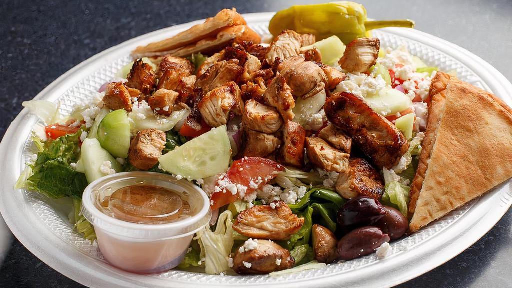 Grilled Chicken Salad · Grilled marinated chicken atop fresh garden greens. W/tomatoes, red onions, cucumber, feta cheese, Kalamata olives, and pepperoncini. Served with homemade dressing and pita slices.