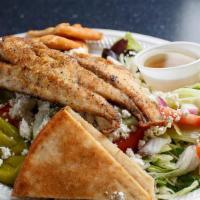 Grilled Redfish Salad · Grilled redfish atop fresh garden greens. W/tomatoes, red onions, cucumber, Feta cheese, Kal...