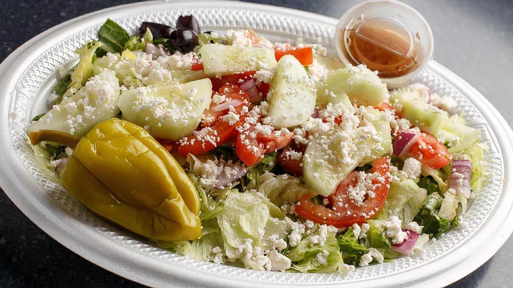Krilakis Greek Salad · Fresh garden greens, tomatoes, red onions, cucumber, feta cheese, Kalamata olives, and pepperoncini. Served with homemade dressing and pita slices.