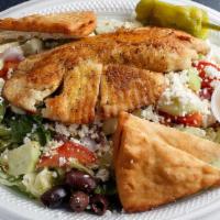 Grilled Tilapia Salad · Grilled tilapia atop fresh garden greens. W/ tomatoes, red onions, cucumber, feta cheese, Ka...