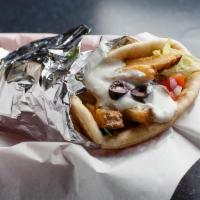 Veggie Gyro · Dressed with lettuce, tomato, red onion, and homemade tzatziki sauce in a pita wrap. Garnish...