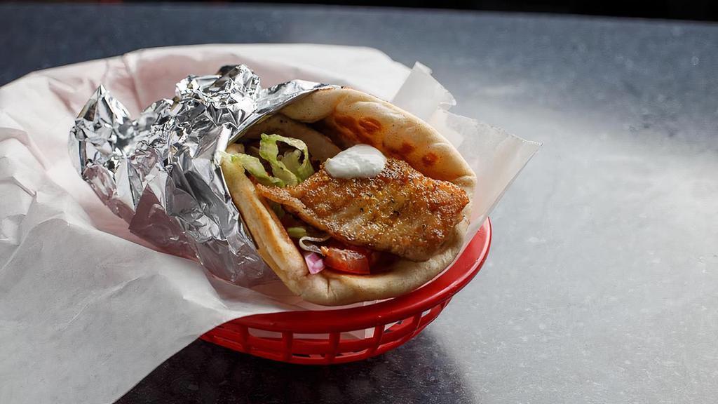 Grilled Tilapia Specialty Gyro · Seasoned fresh tilapia. Dressed with melted mozzarella and feta cheese, grilled red onion, tomato, and homemade tzatziki sauce in a pita wrap.