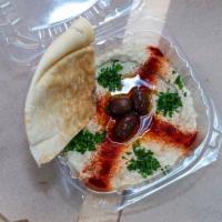 Baba Ganoush · Eggplant with sesame oil dressing served with two pieces of pita.