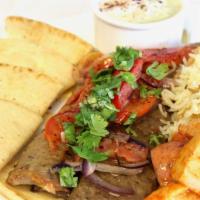 Lamb And Beef Gyro · With Greek salad, pita bread, and rice with tzatziki sauce on top.
