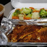 Cajun Catfish Filet · A grilled boneless catfish filet served with rice and steamed broccoli.