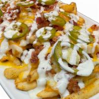 Texas Fries · fries / chile con queso / bacon / house pickled jalapenos / jalapeno ranch drizzle