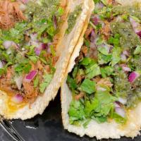 The Champ · corn tortilla / pork carnitas / diced onions / cilantro / salsa verde