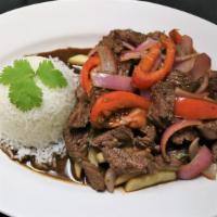 Lomo Saltado · Peruvian style beef stir-fry mixed with onions, tomatoes, cilantro, soy sauce, and served on...