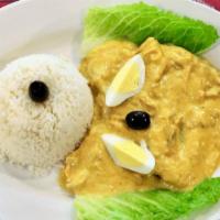 Aji De Gallina · Pulled chicken breast cooked with a creamy ají amarillo sauce. Served with sliced potato, sl...