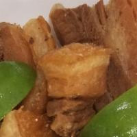 Fried Pork Belly (Chicharrones) · Served with your choice of  Rice,  tostones or fried yuca.