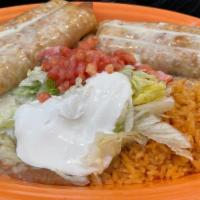 Vegetarian Chimichangas · Flour tortillas with beans, cheese, and sauteed vegetables, fried to a golden brown and topp...