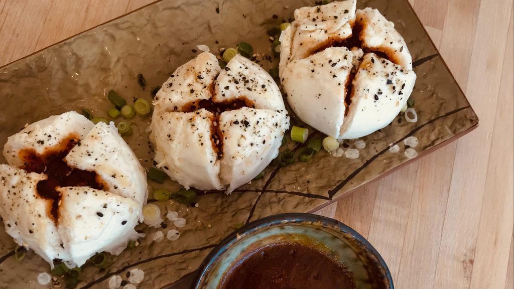 Bbq Pork Baos · Three steamed buns filled with BBQ pork, served with Sriracha BBQ sauce and spicy aioli