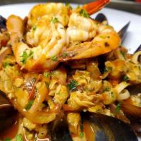 Seafood Tuttormare · Shrimps baby clams mussels in white wine or red sauce over linguine pasta.