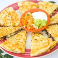 Quesadilla Ranchera · A ten inch flour tortilla grilled and stuffed with retried beans and cheese. Served with sou...