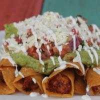 Taquitos · Fried corn tortillas stuffed with chicken. Topped with sour cream, fresh lime pico de gallo,...