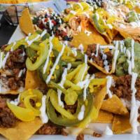 Grave Digger Nachos · Your choice of one protein, bread and butter jalapeños and onions, sour cream, guacamole, an...