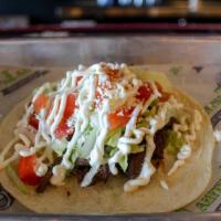 Gringo Skirt Steak · Marinated skirt steak topped with lettuce, tomatoes, queso fresco, and sour cream. Served in...