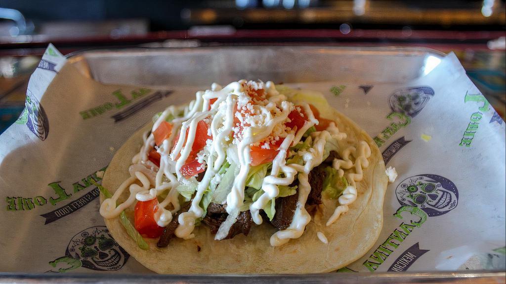 Gringo Skirt Steak · Marinated skirt steak topped with lettuce, tomatoes, queso fresco, and sour cream. Served in a flour tortilla.