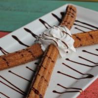 Churros · A cream-filled fried pastry sprinkled with cinnamon and sugar. Topped with a drizzle of choc...
