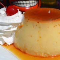 Flan · An authentic dessert made from caramel baked custard. Topped with a drizzle of chocolate.