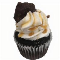Chocolate Caramel Turtle · Chocolate cake, filled with a caramel filling, topped with vanilla buttercream, finished wit...