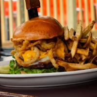 The Cowboy Burger · Bacon, fried onions straws, American, and provolone cheese and our signature BBQ sauce - cow...