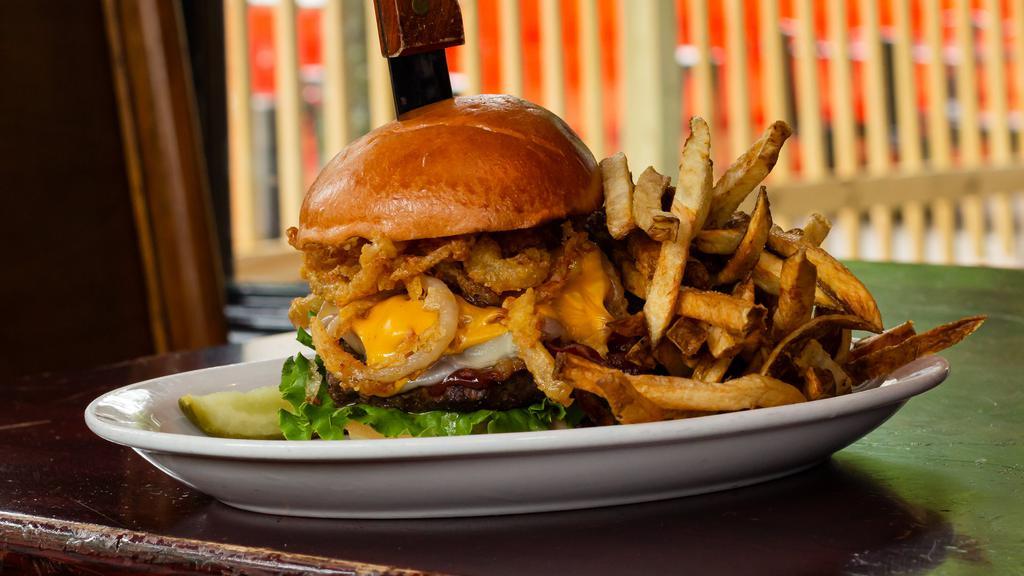 The Cowboy Burger · Bacon, fried onions straws, American, and provolone cheese and our signature BBQ sauce - cowboy up!