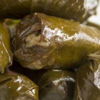 Dolmades · Stuffed grape leaves with feta cheese.