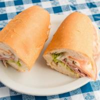 Italian Sub · Ham, Genoa, salami, provolone, onions, hot peppers and dressing. Served with lettuce, tomato...